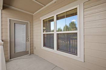 Large, private, covered, fenced-in patio or balcony with large windows.